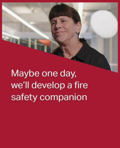 An image card featuring Professor Elizabeth Weckmann inside a red rectangle with the statement "Maybe one day, we’ll develop a fire safety companion" in white text overlayed over it.