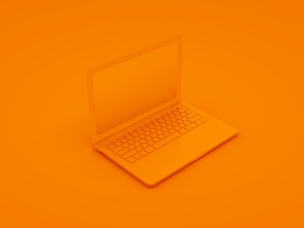 An orange laptop on an orange background