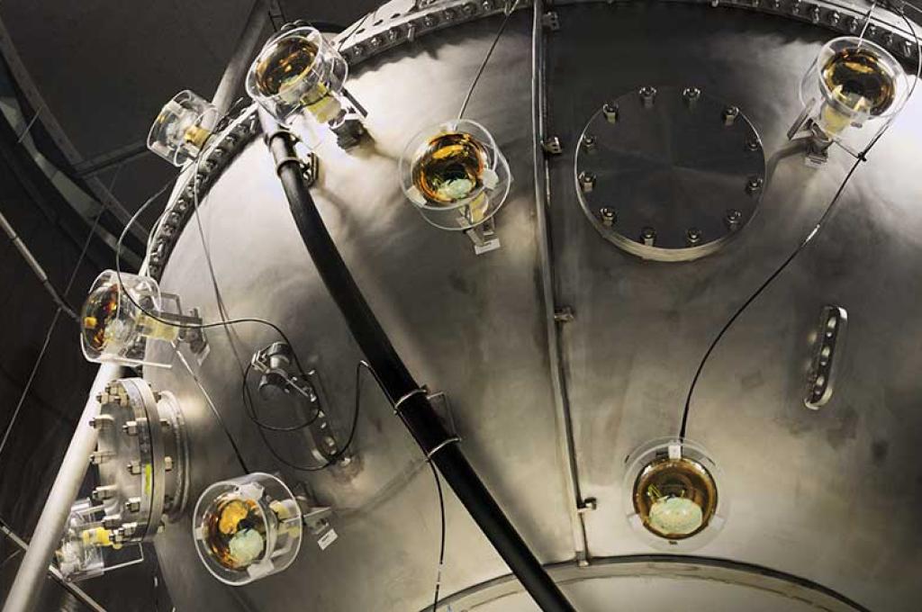 A large steel sphere in a darkened room.